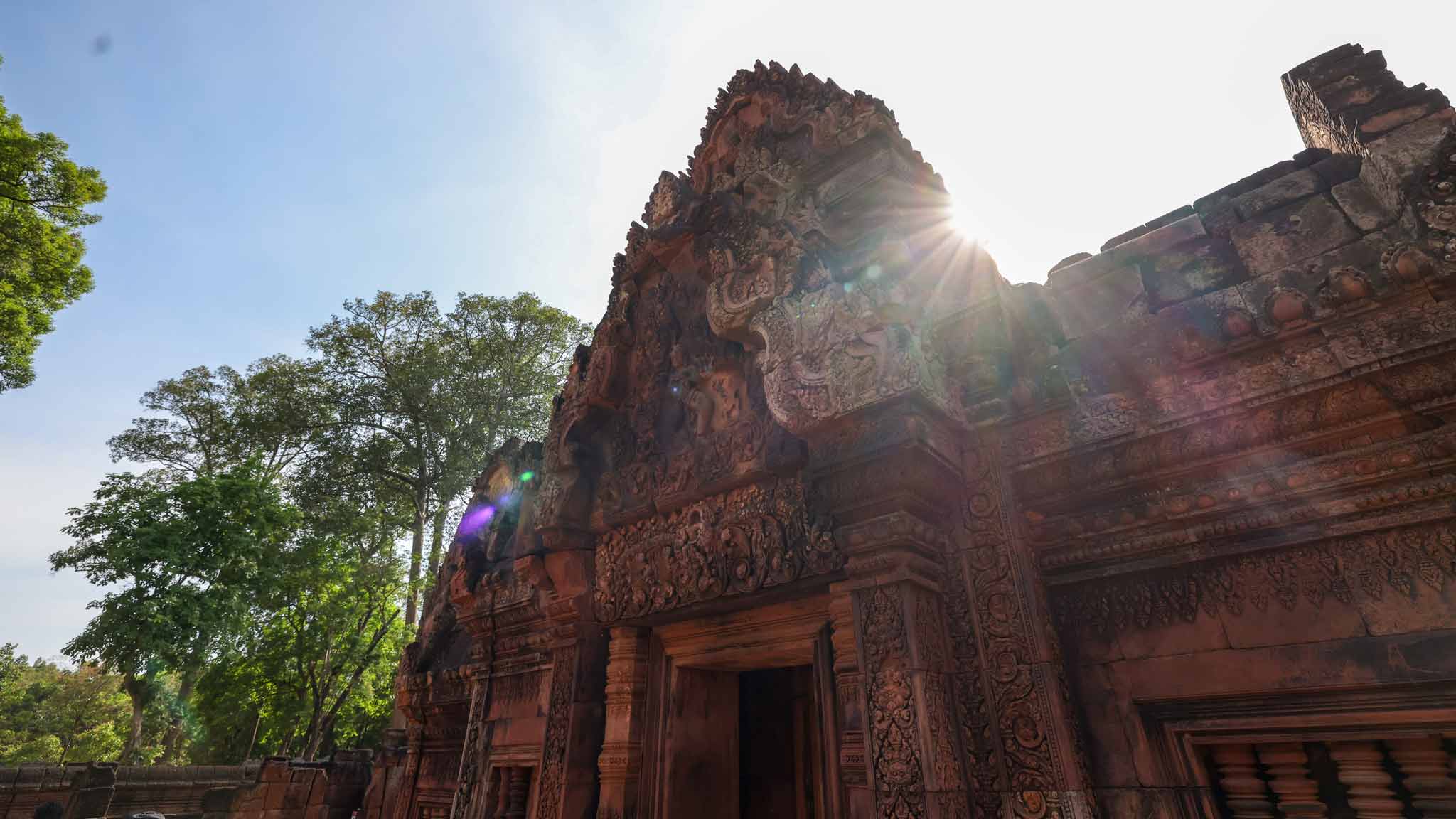 Detailed carvings in pink sandstone at Banteay Srei temple in Siem Reap.