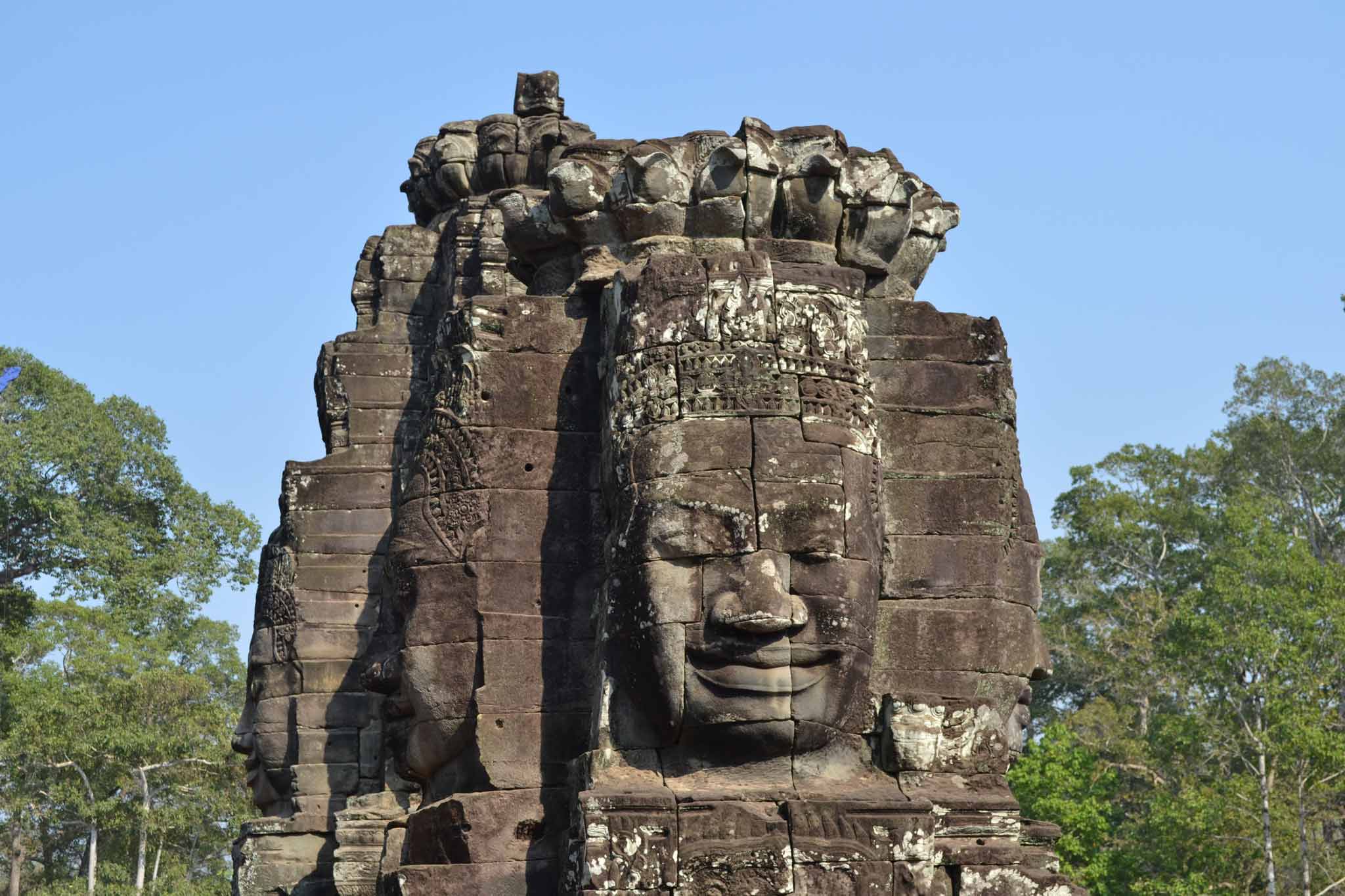 Close-up of the carved faces on the walls of Bayon Temple in Siem Reap.