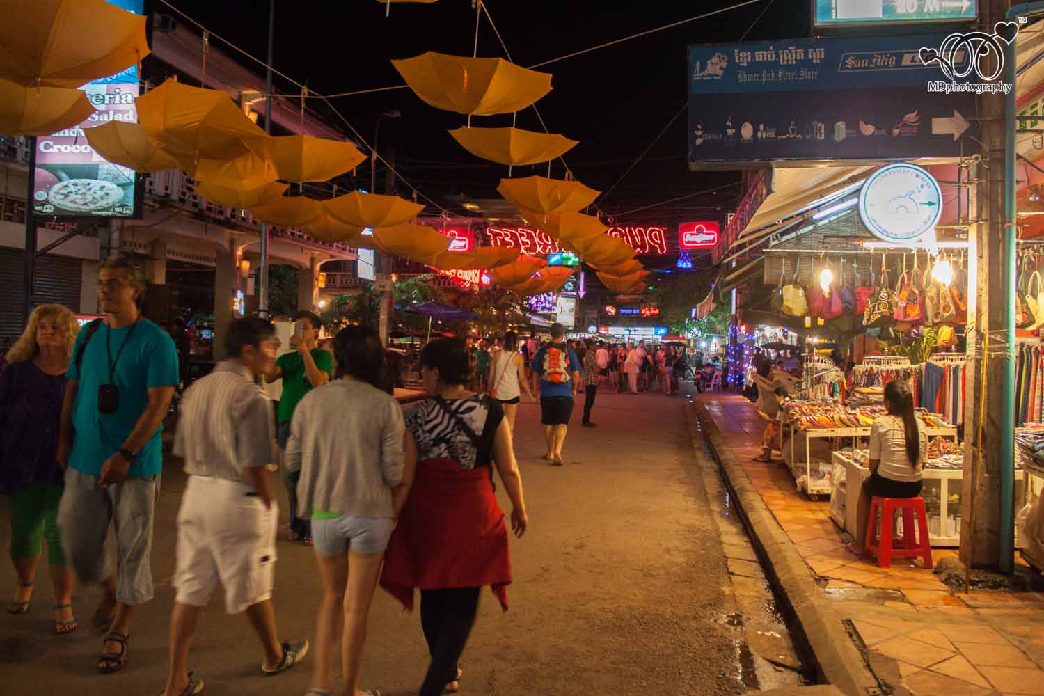Colorful lights and crowds of people on Pub Street, a popular nightlife destination in Siem Reap.