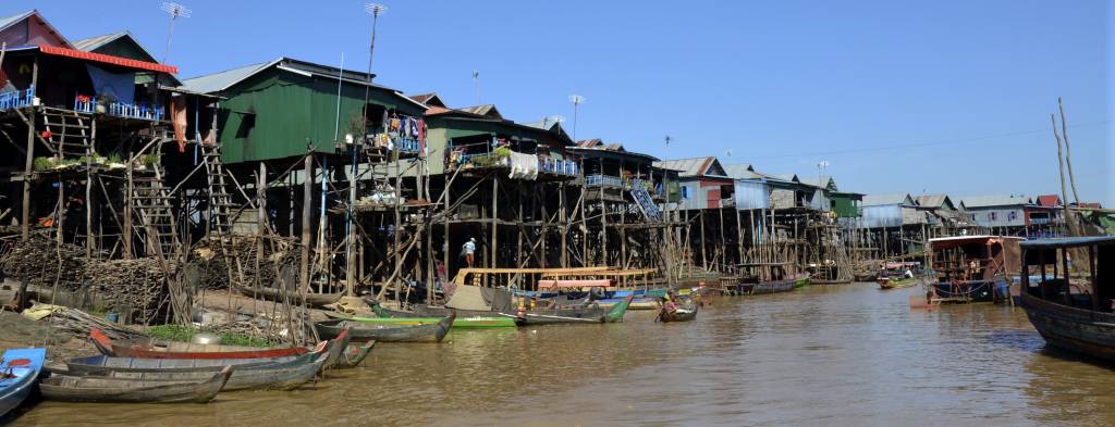 Tonle Sap Lake, the largest lake in Southeast Asia, with greenery and boats visible.
